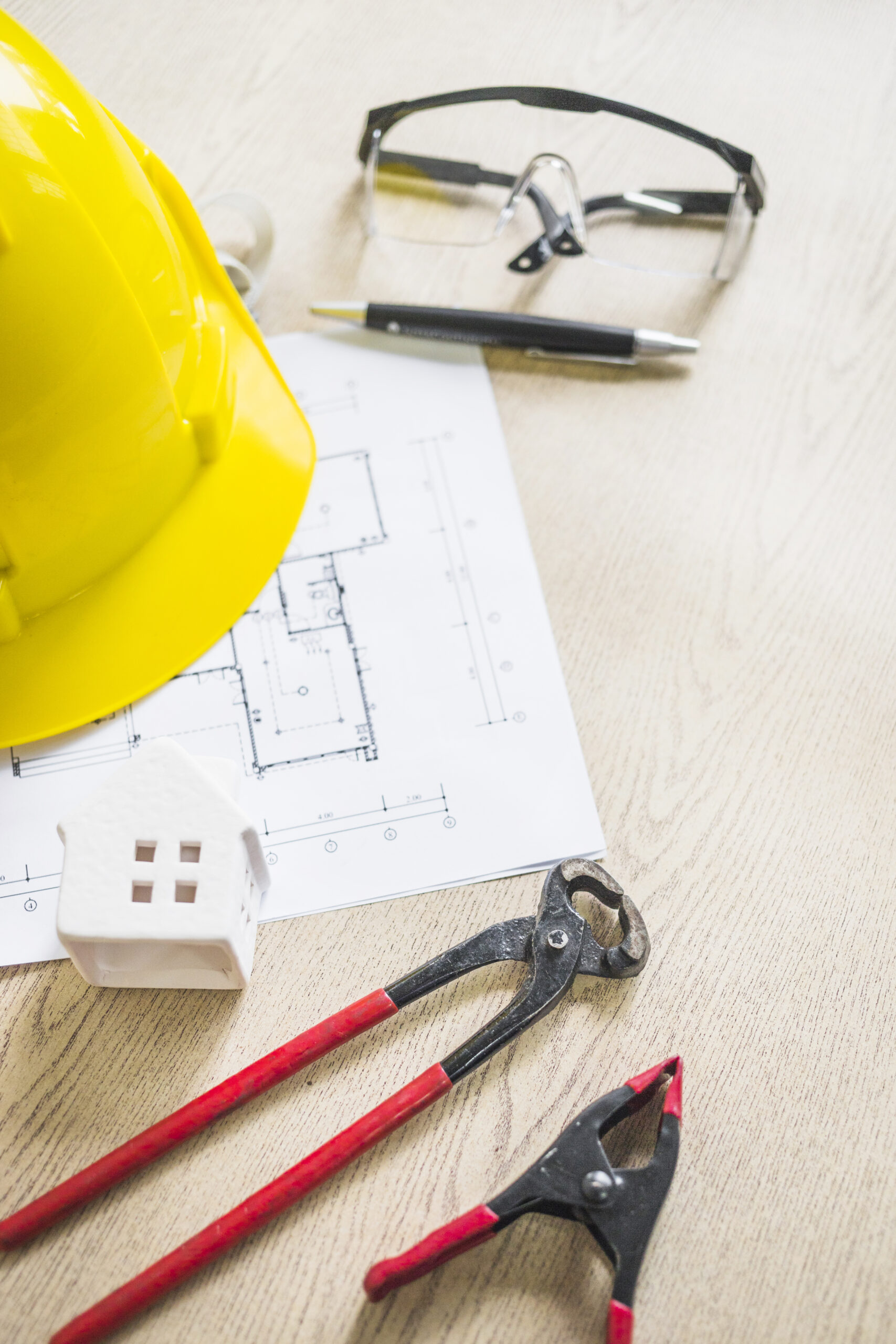 toy-house-near-safety-construction-gear